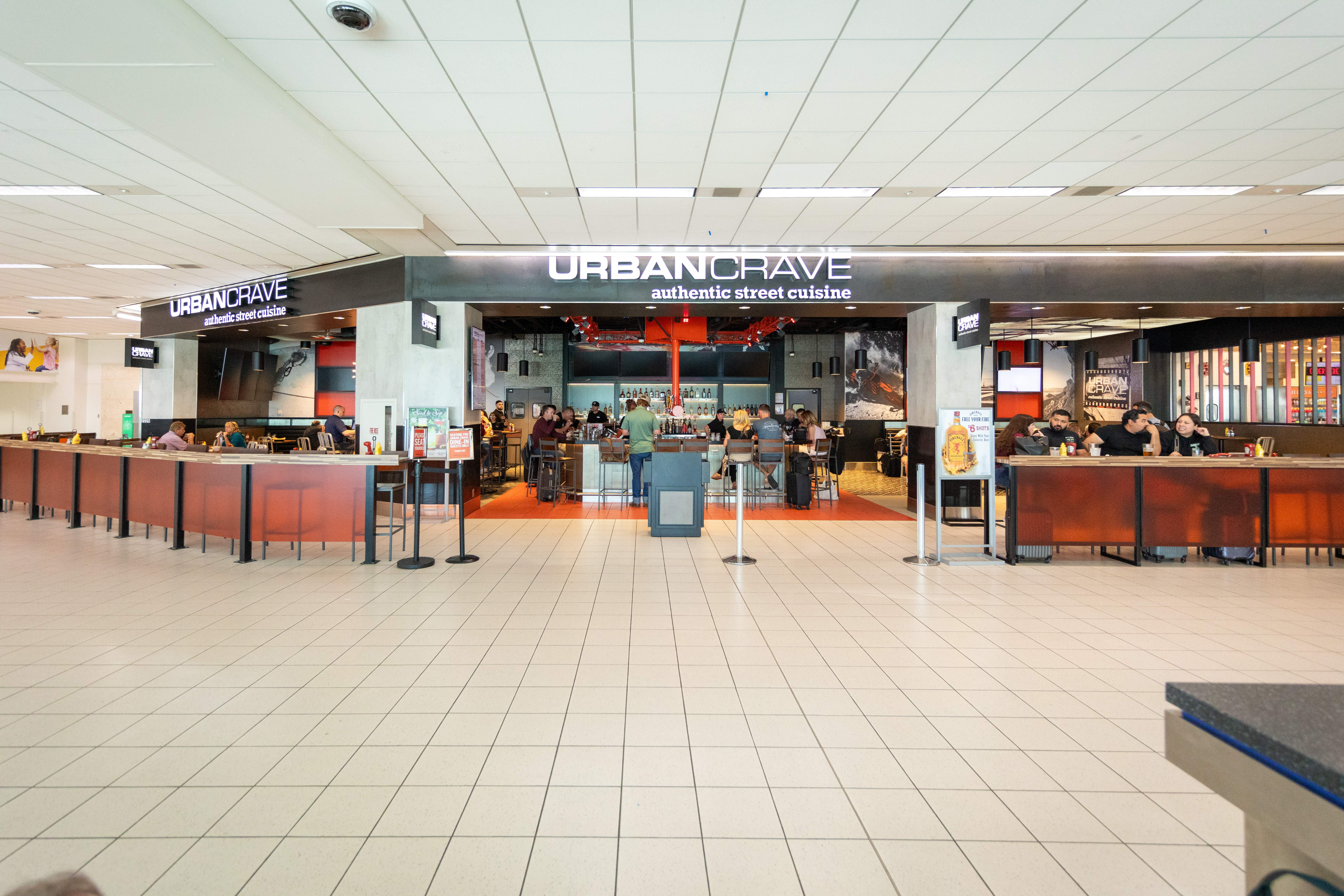 Fast food restaurants and food court counters in a shopping mall interior.