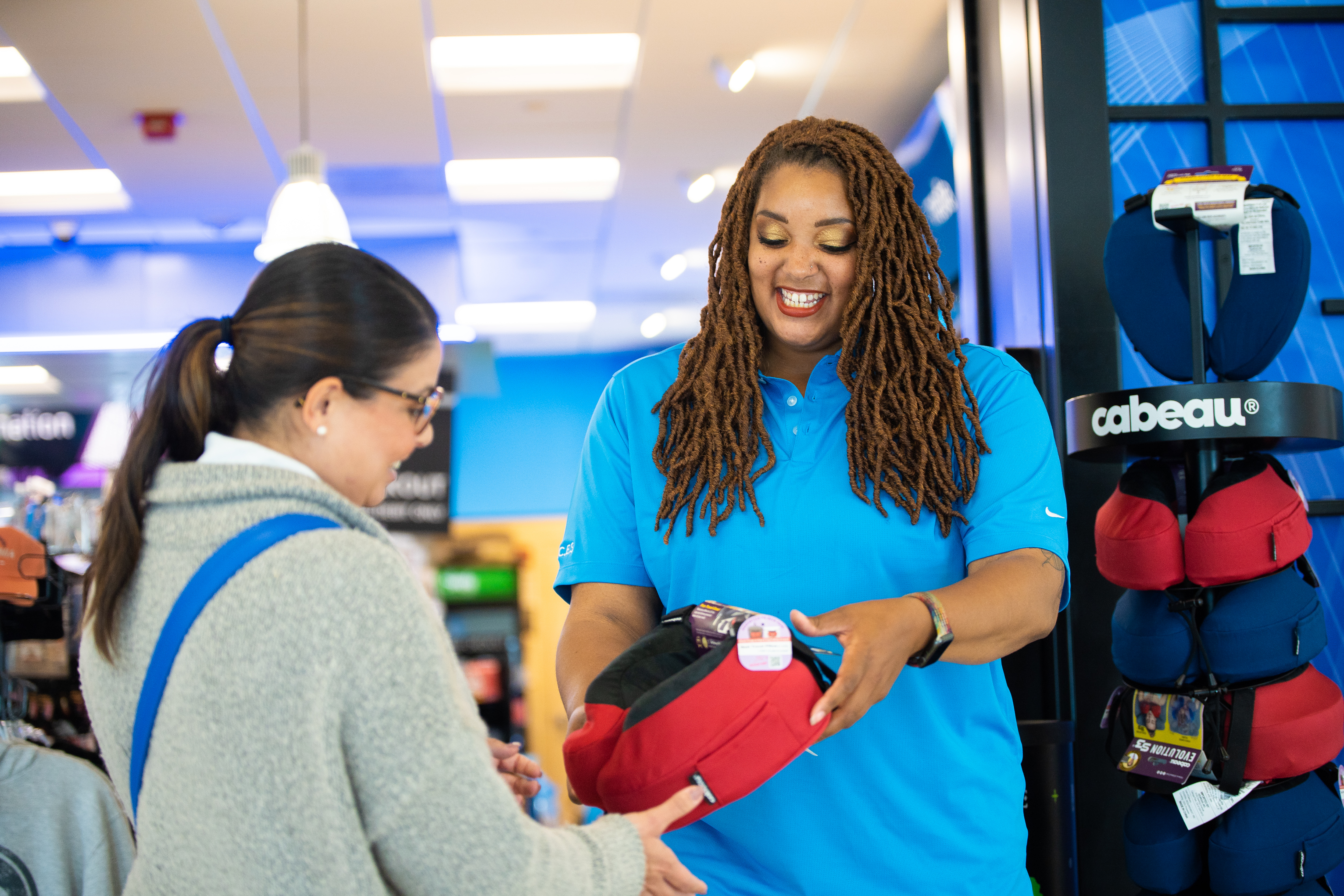 ONT Customer Service Team member helping a passenger.