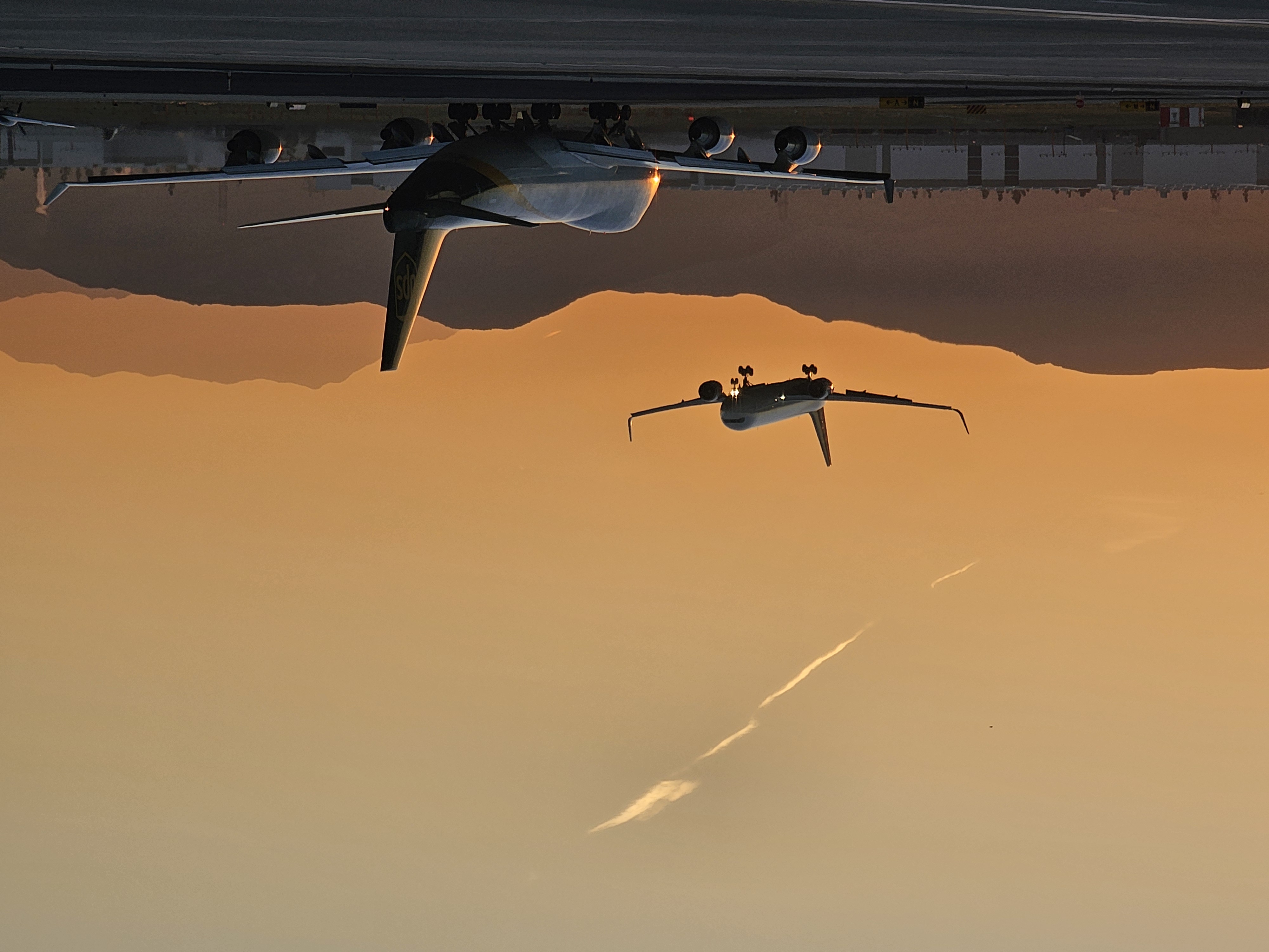 Airplane flying into the sunset