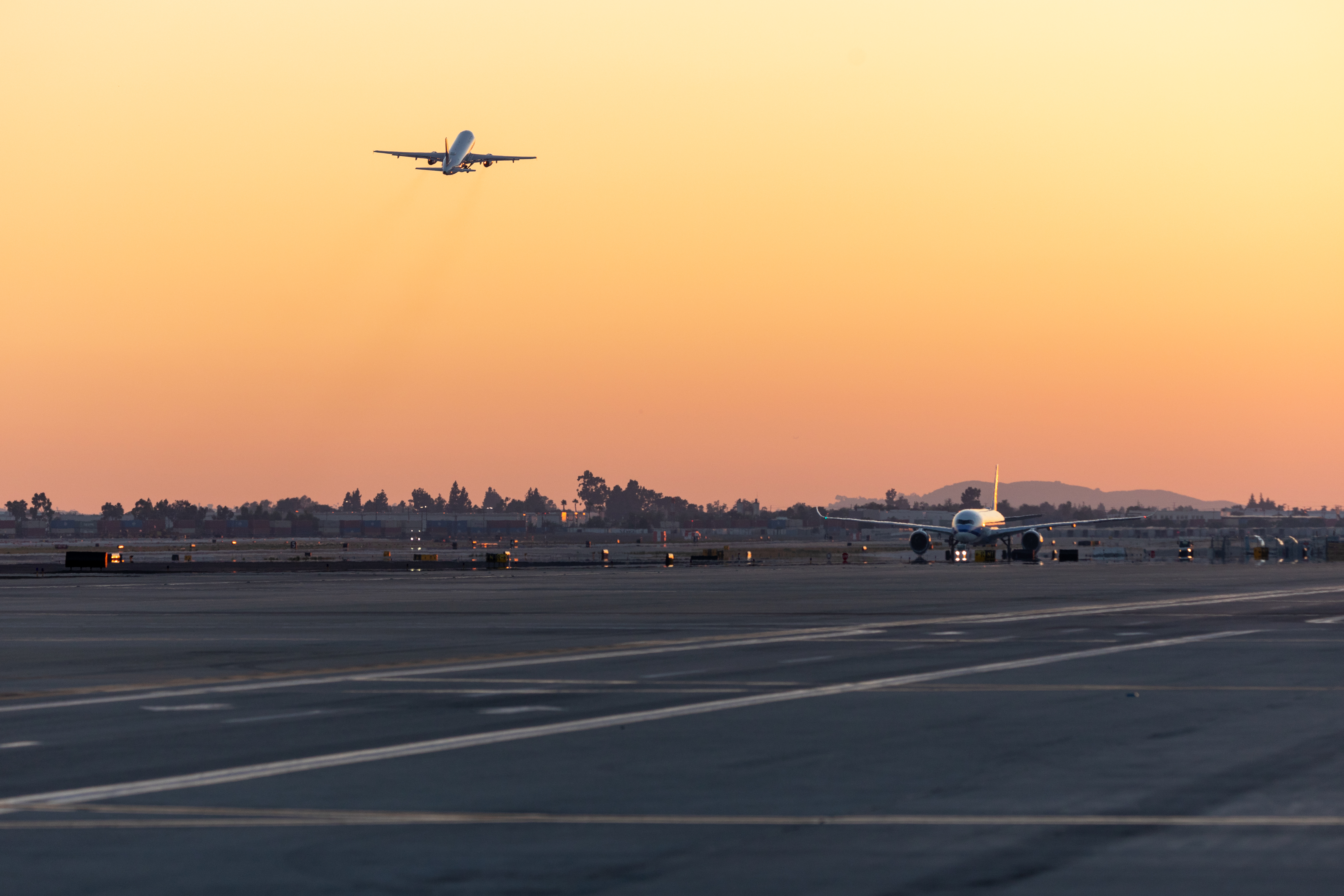 One plane taking off and a second plane landing. 