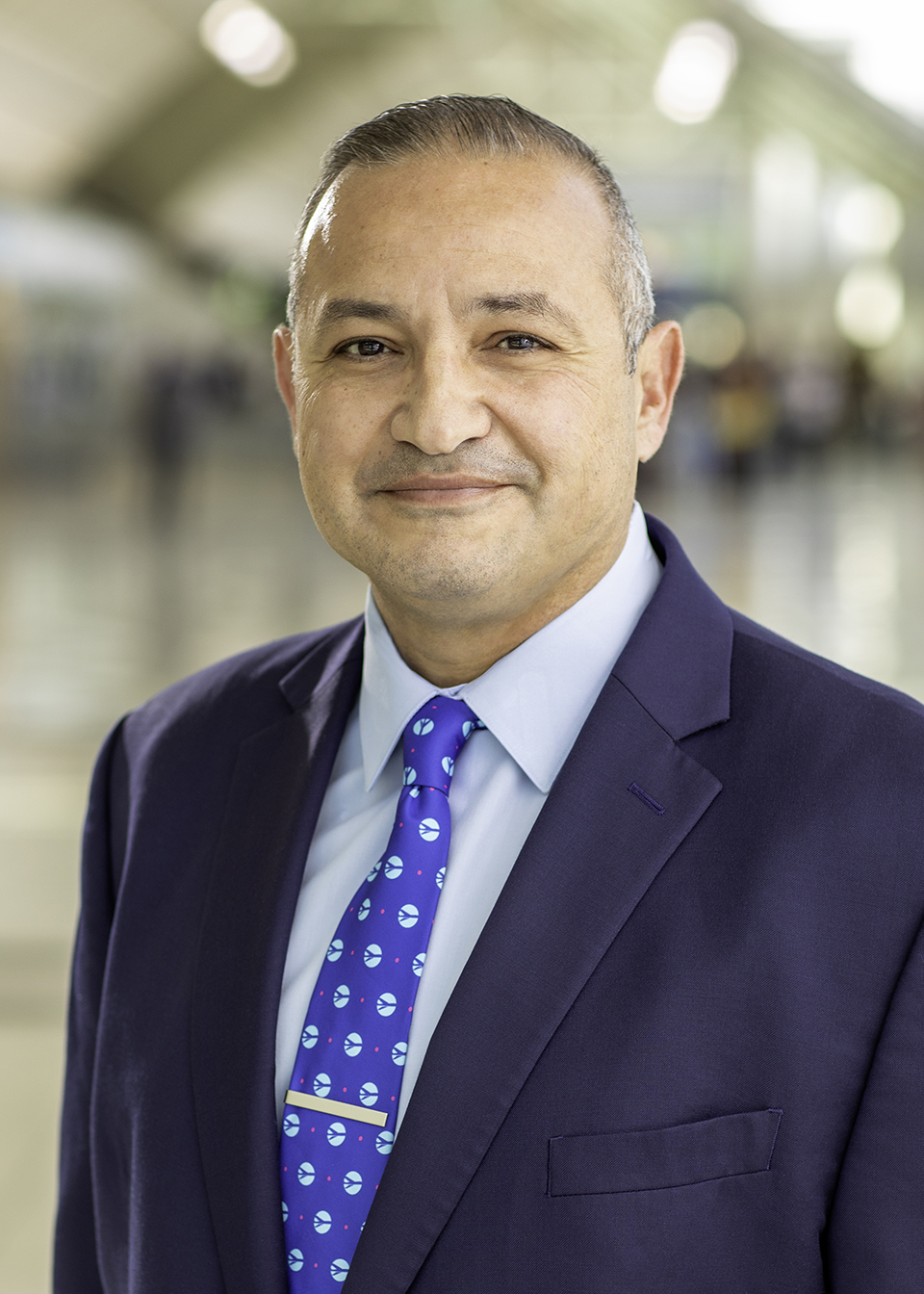 Photo of O N T C E O, Atif Elkadi, smiling in the airport. 