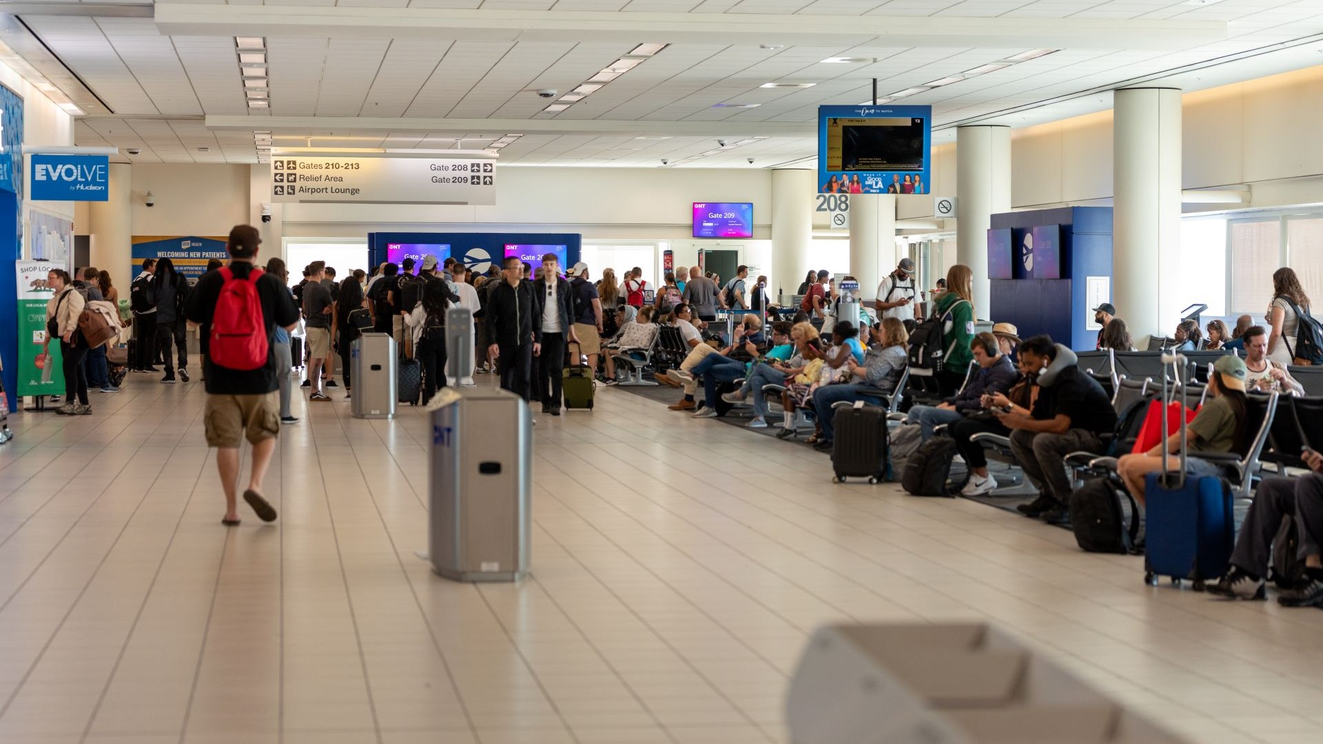 man walking ONT terminal in flip flops
