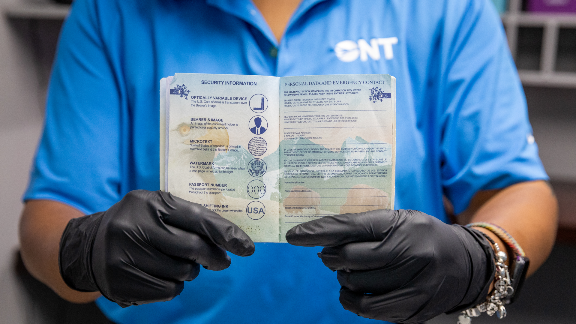 Closeup of ONT lost & found employee holding up passport id 