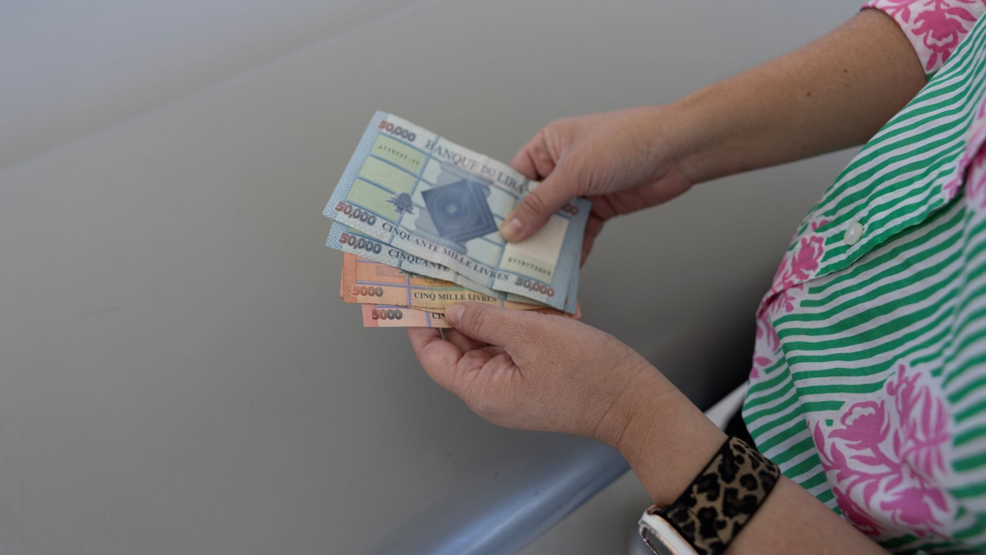 woman holding foreign exchange money