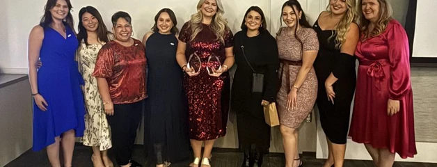 OIAA staff posing with their awards
