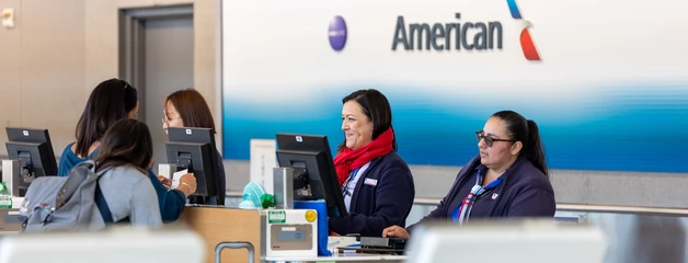 American Airlines customer service counter with staff assisting passengers