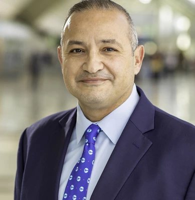 Photo of O N T C E O, Atif Elkadi, smiling in the airport. 