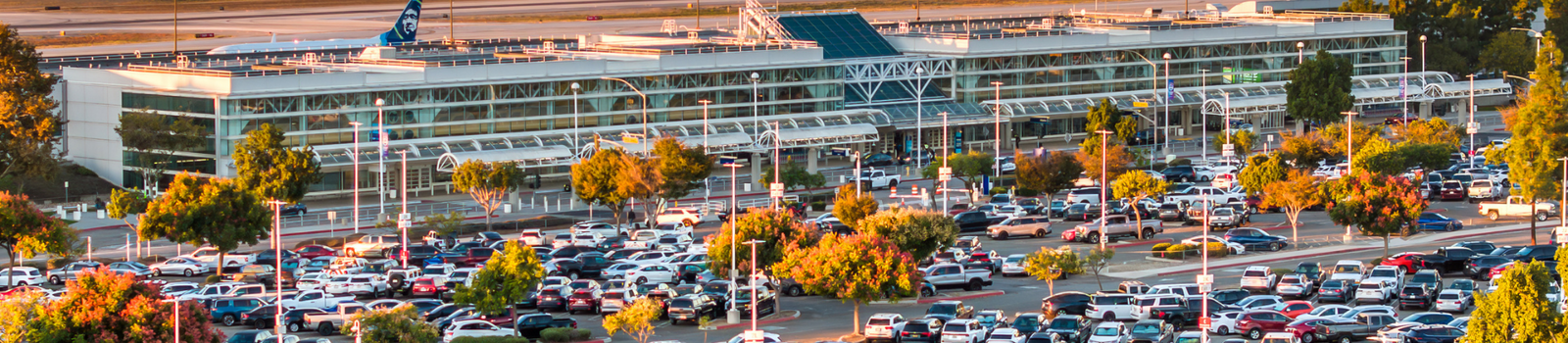 Full lot of cars in front of the terminal. 
