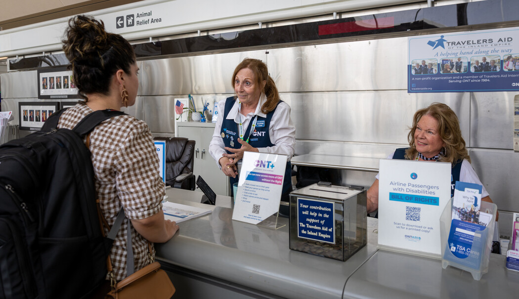 Traveler asking questions at the travelers aid desk 