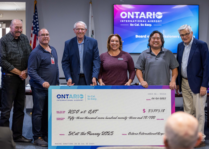 Group of people presenting a large ceremonial check at an Ontario Lottery event.